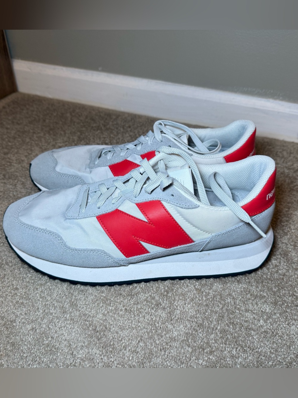 New Balance Light Gray Sneakers with Red 'N' Accent